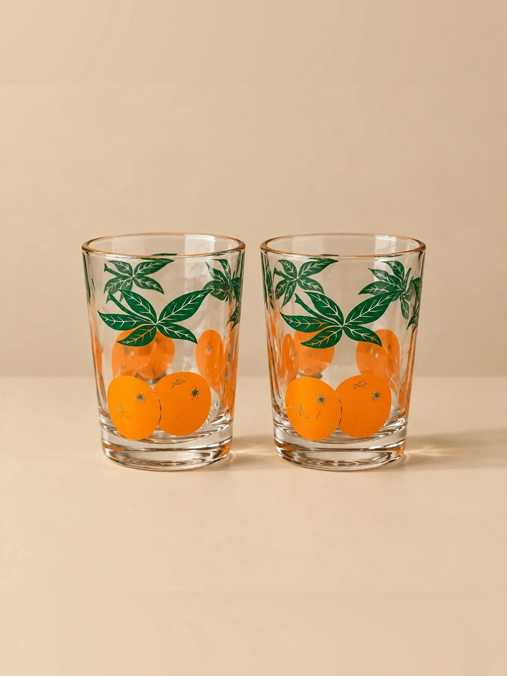 Anchor Hocking Set of 2 orange and green leaf juice glasses from the 1970s.